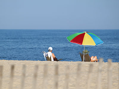 Guests of Harrison Hall Hotel in Ocean City Maryland relax on the beach.