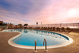 Boardwalk hotel with two outdoor pools.
