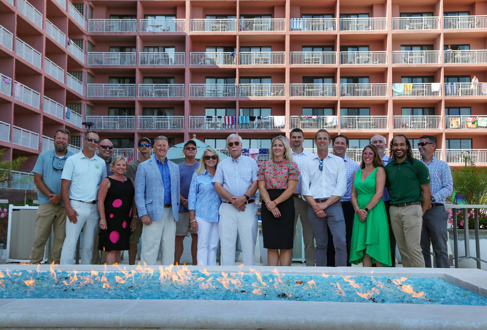 A group picture of Harrison Group owners, executives and department directors at the Original Pool Bar's ribbon cutting