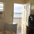 Inlet view room with a view of the inlet, window air conditioner, tv and refrigerator. 
