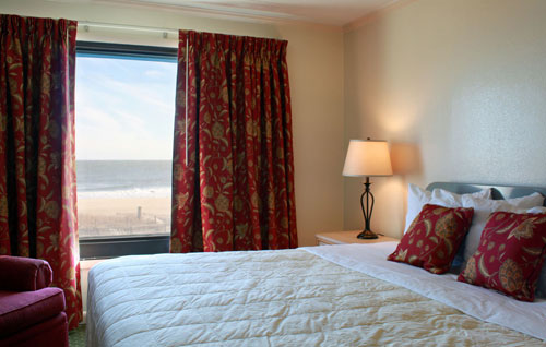 A comfortable and warm bedroom overlooking the ocean in unit 1003