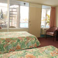 Pool view room with large windows overlooking the pool and spiral staircase.