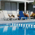 Chairs and tables align the outdoor pool