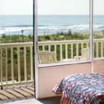 The oceanfront room has Large glass windows and a porch where you can sit and see the ocean and beach.