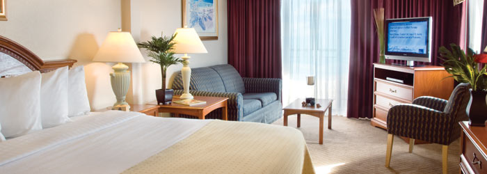 Holiday Inn Oceanfront room with separate sitting area and oceanfront balcony.