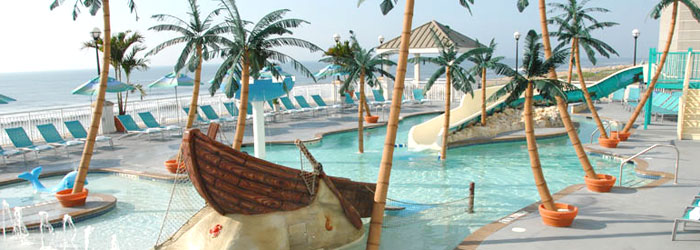 Hilton Suites Kid Activity pool overlooks the ocean with slides and waterfalls.