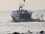 A boat going through the inlet.