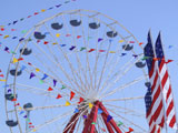 Ocean City Springfest booths and people eating food with a Farris Wheel in the background